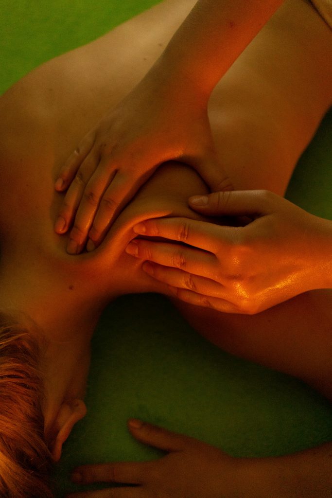 From above of anonymous female lying on soft massage table and relaxing during massage session
