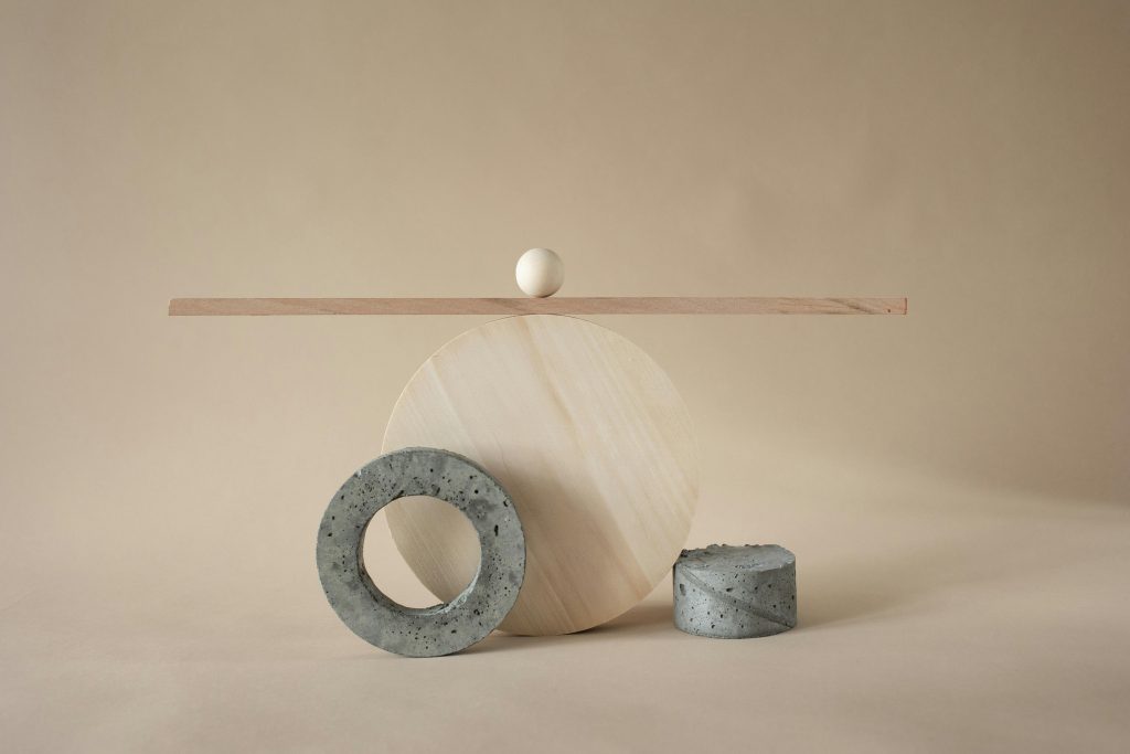 Abstract composition of geometric shapes and textures on a beige backdrop.